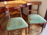 two chairs that are next to a table in a room