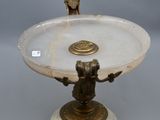 a white marble pedestal with a bird on top of it