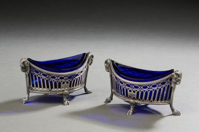 pair of silver and blue glass chairs on a white surface