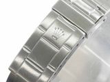 a close up of a watch on a white surface