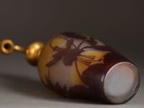 a picture of a glass bottle with a flower design on it