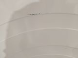 a close up of a toilet bowl with the lid up