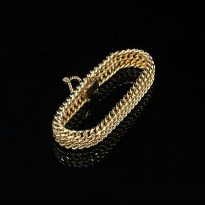 un bracelet en or sur une surface noire