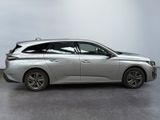 the silver car is parked on the concrete floor in the room