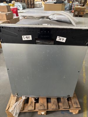 an old dishwasher sitting on a pallet in a warehouse