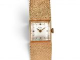 an image of a close up of a wrist watch on a white surface