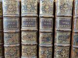 many old books that are stacked on top of each other