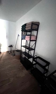 a room with a shelf and a chair in it