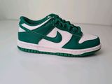 a close up of a pair of green and white shoes