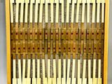 a wooden display case filled with lots of yellow and red notes