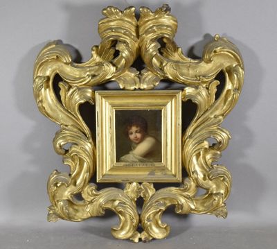 a gold frame with a picture of a child in it