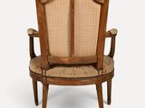 an old wooden chair with a cane back and a cane back seat