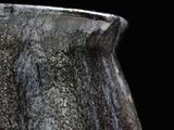 a close up of a vase on a black background