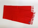 red scarf with fringes laying on a white surface