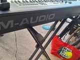 a keyboard that is sitting on a stand next to a bike