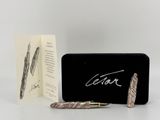 an image of a pen sitting next to a box with a pen in it