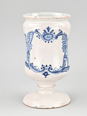 a blue and white vase sitting on top of a table