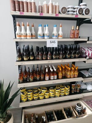 many bottles of beer on the shelves in the store