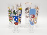 trois verres aux motifs différents posés sur une surface blanche