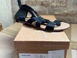 black sandals on a cardboard box on top of a cardboard box