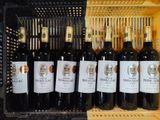 many bottles of wine in a crate on the shelf