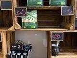 many wooden crates with different types of items on them