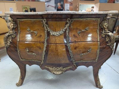 a marble top chest of drawers on display in a store