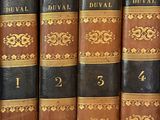 several books are lined up in a row on a shelf