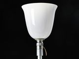 a lamp that is on a metal pole with a black background