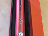 a red pen in a black case sitting on a table