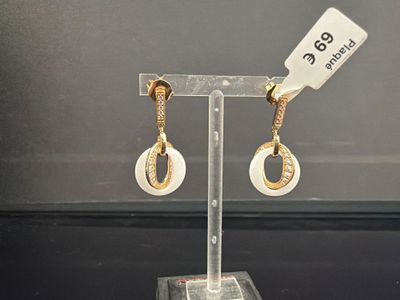 une paire de boucles d'oreilles exposées sur un présentoir