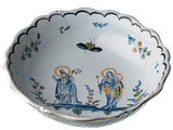 a white bowl with blue and yellow designs on it