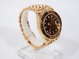 an image of a rolex watch with a brown dial on a gold bracelet