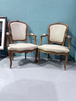 two chairs sitting next to each other in a room