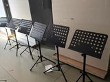 several music stands are lined up in a row in a room