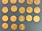 some gold coins are arranged in a square pattern on a table