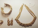 several pieces of jewelry are displayed on a white surface