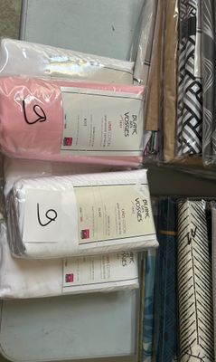 a lot of different types of fabric on a shelf