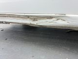 a close up of a car ' s front bumper with a denting on it