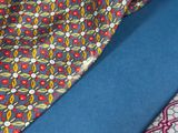 three different colored ties on a blue surface with a blue background