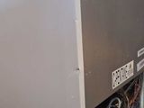 a silver refrigerator sitting on top of a pallet
