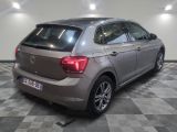 the back end of a silver volkswagen vw polo parked in a garage