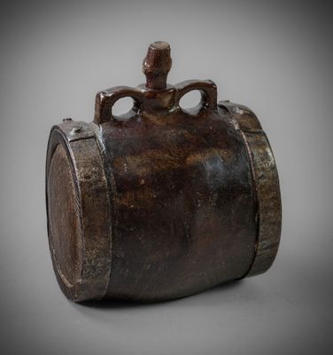 an old wooden barrel with a handle on a gray background