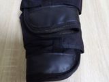 a pair of black boots that are on a wooden floor