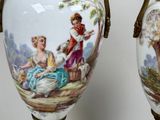 two vases that have pictures of people on them