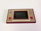 an image of a small game console sitting on top of a white table