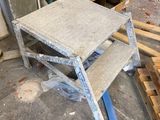 a small step stool sitting in the middle of a room