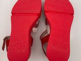 a pair of red shoes on a white surface