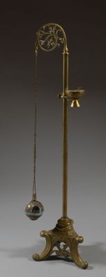 an image of a brass plate with a pendulum and a ball hanging from it