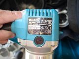 a person holding a blue electric driller in their hand
